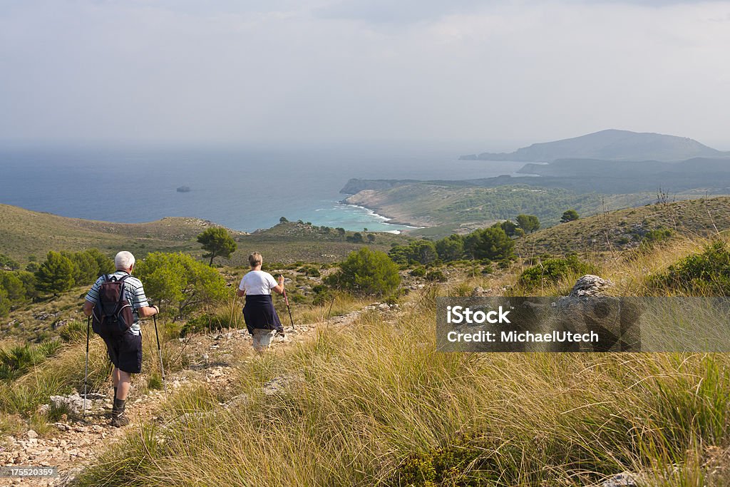 Sênior Homem e mulher caminhadas à beira-mar - Foto de stock de Maiorca royalty-free