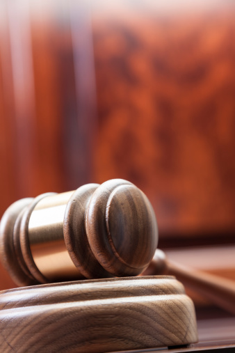 Close-up of gavel on table.