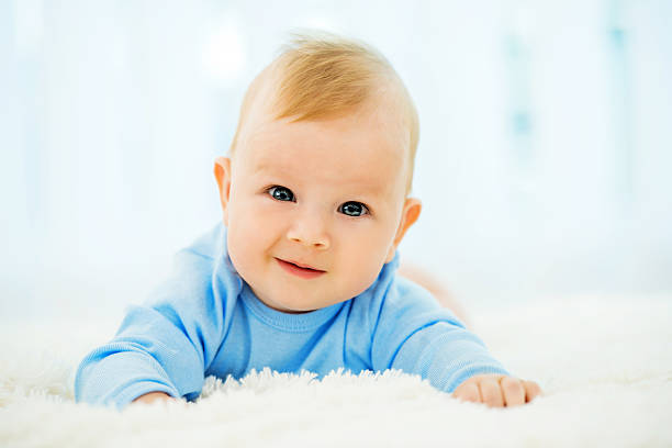 istock Beautiful baby lying on the soft bed 175520923