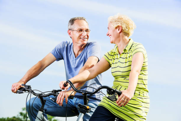 istock Cheerful mature couple riding bicycles in park 175520984
