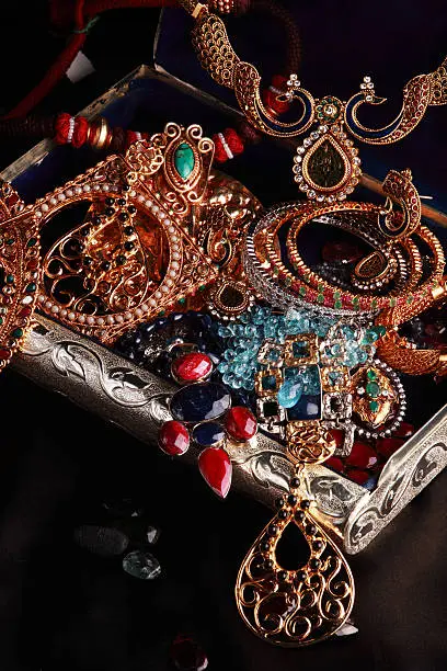 Treasure chest full of jewels, jewelry and other personal accessories.