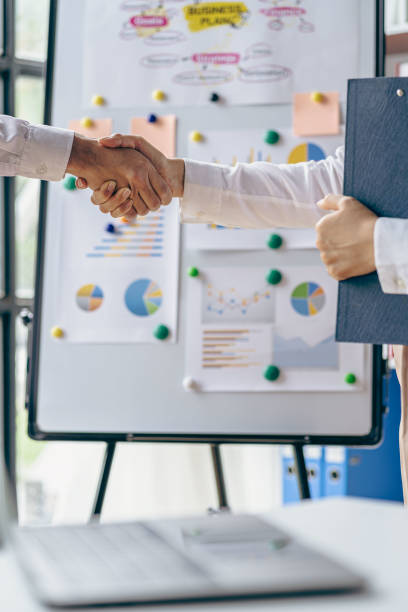 istock Businessmen join hands for teamwork in business mergers and acquisitions, successful negotiations, with partners celebrating partnership. Close-up pictures 1755220374