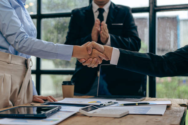 istock Businessmen join hands for teamwork in business mergers and acquisitions, successful negotiations, with partners celebrating partnership. Close-up pictures 1755220376