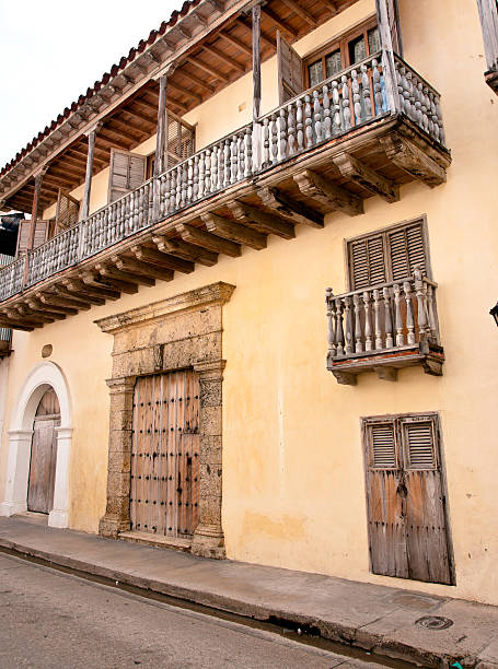 istock colonial architecture: classic yellow facade with wooden balconies 175522089