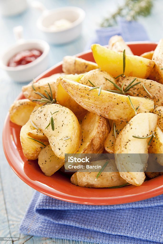 Roasted potatoes Roasted potatoes with rosemary in a bowl Baked Potato Stock Photo