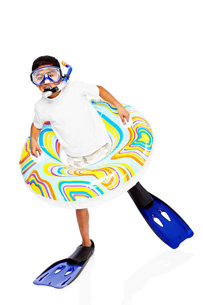 Portrait of happy little boy wearing snorkel equipments on white background