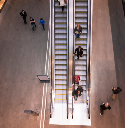 Aerial view of people walking on escalator in London.