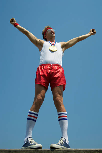istock Gold Medal Nerd Athlete Stands with Arms Raised 175523735