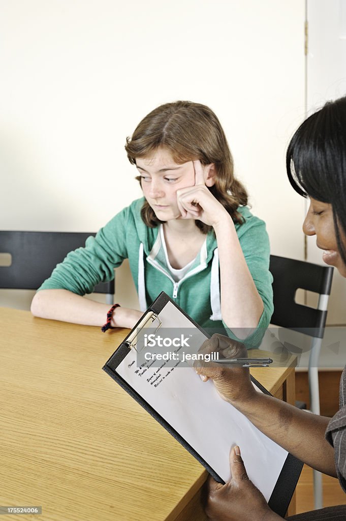 Teenager in counselling session Pyschiatrist or teacher counselling sullen teenagerMore like this Interview - Event Stock Photo