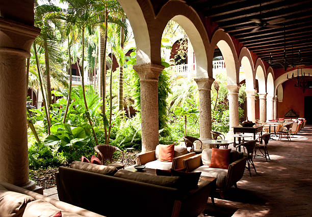 istock colonial architecture: lush courtyard with tables around it 175524235