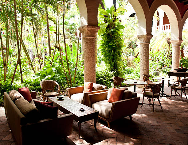 istock colonial architecture: lush courtyard with tables around it 175524240