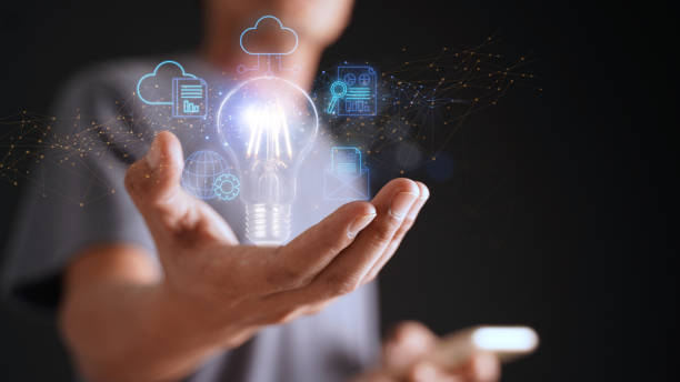 istock An entrepreneur holding an abstract light bulb uses the internet to connect data on his mobile device through artificial intelligence. Concept of data storage, large data warehouse on cloud computing. 1755242573