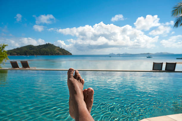 istock Feet up by the pool, relaxing in paradise 175524748