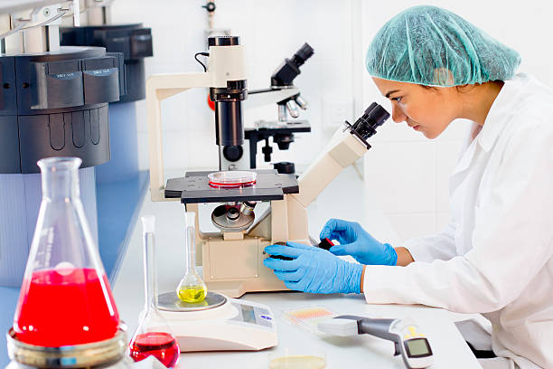 istock Researcher looking into a microscope at the laboratory 175524787