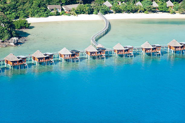 Over water bungalow resort Over water bungalow resort from the air fiji stock pictures, royalty-free photos & images