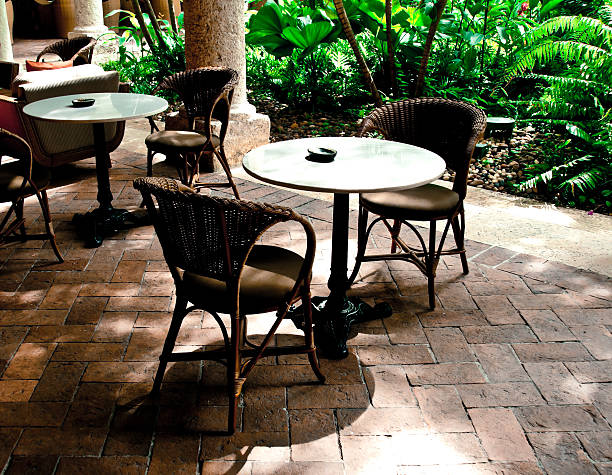 istock colonial architecture: lush courtyard with tables around it 175524810