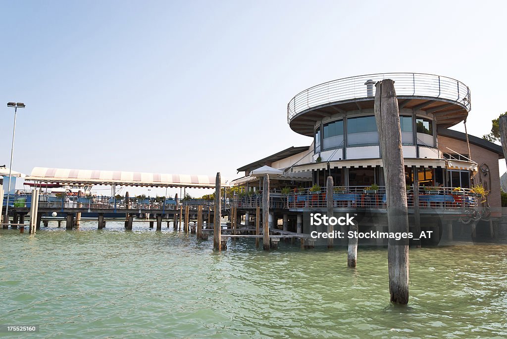 Punta Sabbioni Cavallino Treporti Ferry Port The small ferry harbor Punta Sabbioni in Cavallino Treporti, North Italy, connects the shore of Italy with the world famous historic lagoon town Venice, UNESCO world heritage site. Wide angle view, focus on foreground. All brands have been retouched or blurred. Innovation Stock Photo