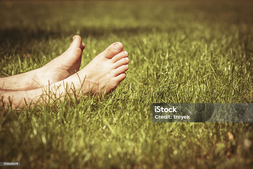 barefoot in the grass Adult Stock Photo