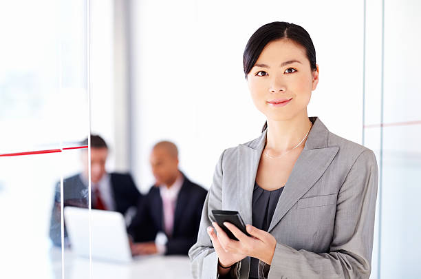 istock Attractive Female Executive Holding Cell Phone 175525587
