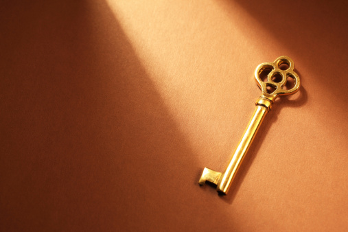 Light shining on golden skeleton key.