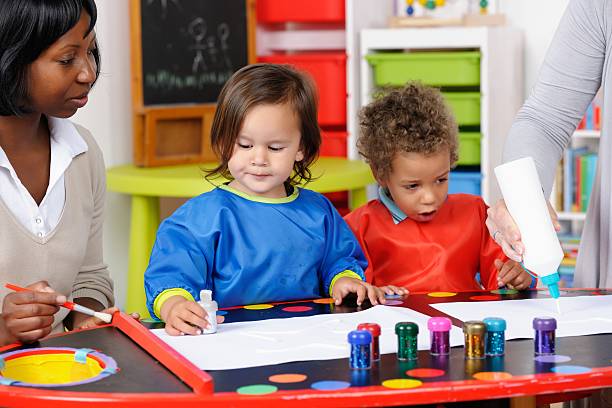 istock Toddler/ Little Boy Excited By Carer Squeezing Glue 175525799