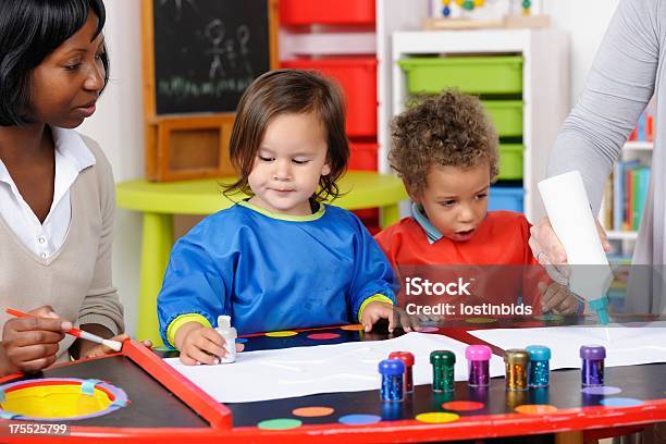 Toddler Little Boy Excited By Carer Squeezing Glue Stock Photo - Download Image Now
