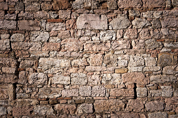 historic stone wall Wall of irregular stonea in historic italy. old stone wall stock pictures, royalty-free photos & images
