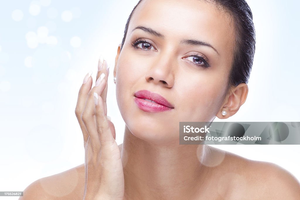 Magic skin lotion or moisturizer "A beautiful woman is applying a lotion, like anti-aging or moisturizer in her face.Digitally enhanced with a prominent defocused sparkling lights bokeh effect for that touch of a magic feeling." Facial Mask - Beauty Product Stock Photo