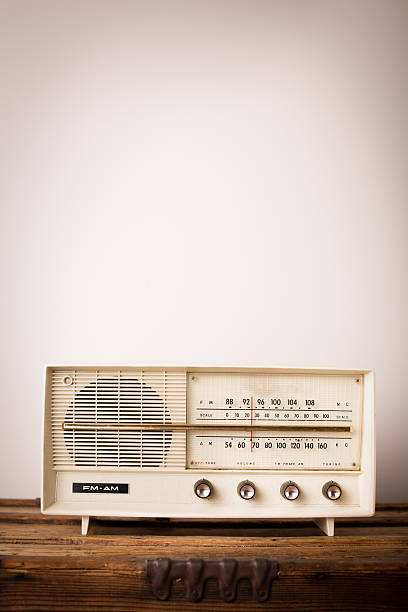 Vintage Beige Radio Sitting on Wood Table, With Copy Space "Slightly desaturated, color image of a vintage beige radio sitting on a wood table, with copy space." bakelite stock pictures, royalty-free photos & images