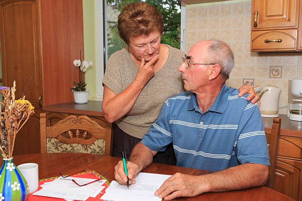 istock Senior couple going over bills 175527599