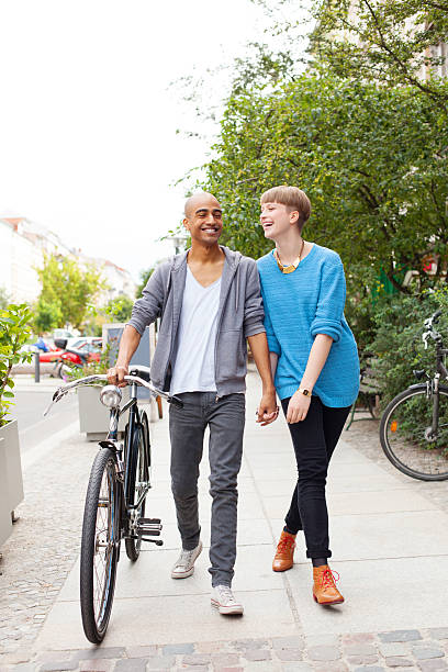 istock Young couple with bicycle walking on the street 175528070