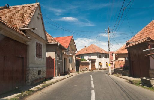 Narrow road through little village near Sibiu, Romania.