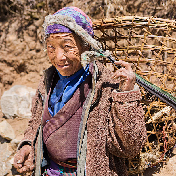 istock Old woman carrying basket 175528160