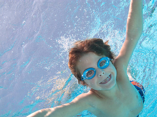 istock Boy Underwater In Swimming Pool With Big Smile 175528307