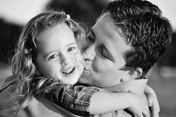 istock father and daughter hugging black and white 175528451