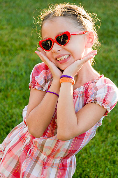 Very Happy Girl with Heart Shaped Sunglasses stock photo