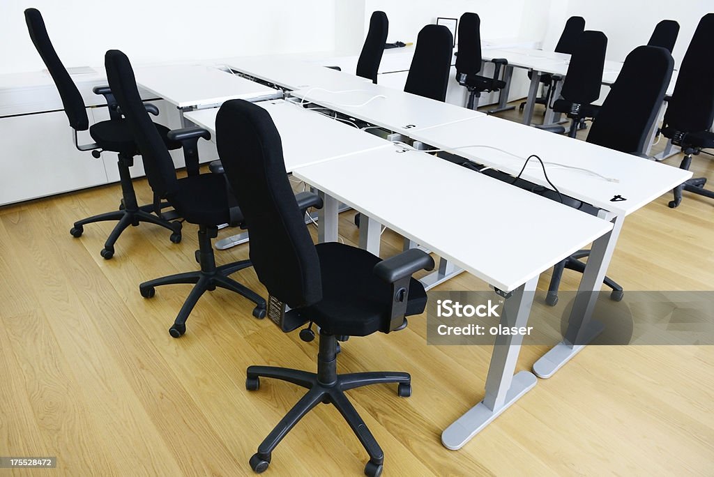 Office desks with comfortable chairs Modern office with wooden floor. Internet connections / seats ready to use for consultants and for education purposes. Built Structure Stock Photo