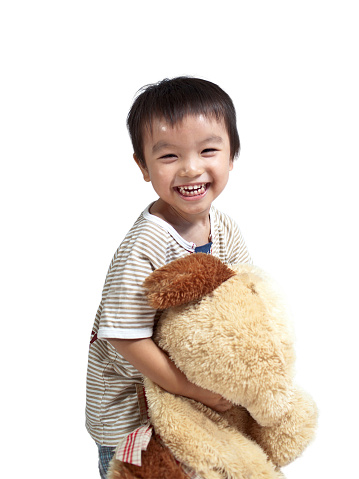 3 year old boy playing with stuffed toy happily on white background
