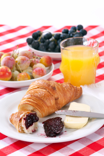 Breakfast with Croissant and Juice. Selective focus, shallow DOF.