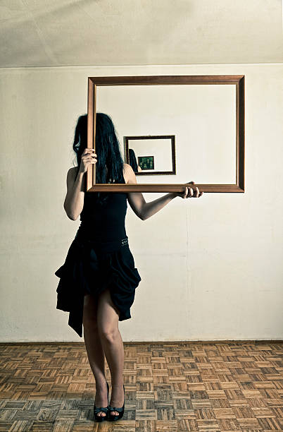istock Woman holding a picture frame 175529216