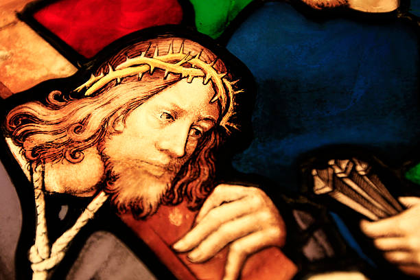 Detail of stained glass window showing Jesus carrying his cross. stock photo