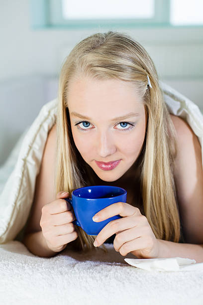 istock Young Woman drinking Coffee or Tea 175531596