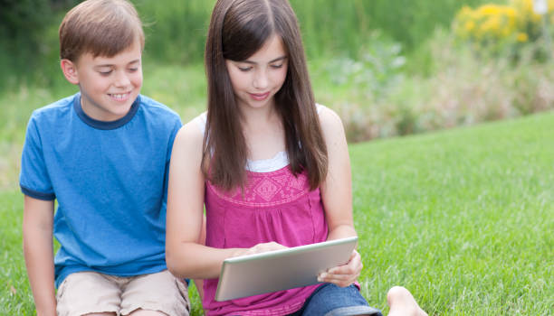istock Girl and Boy Playing on a Computer Tablet 175532222