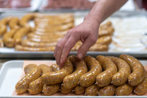 istock Isolated close up high resolution image of the process of creating hand made raw uncooked sausages at a boutique butcher shop- USA 1755322979