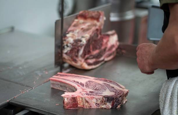 istock Isolated close up high resolution image of beef/ meat cutting and preparation process in a boutique butcher shop- USA 1755325116