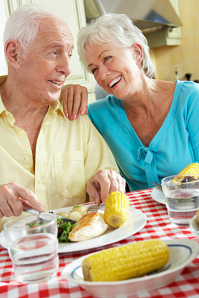 istock Senior Couple Eating Meal Together In Kitchen 175532887