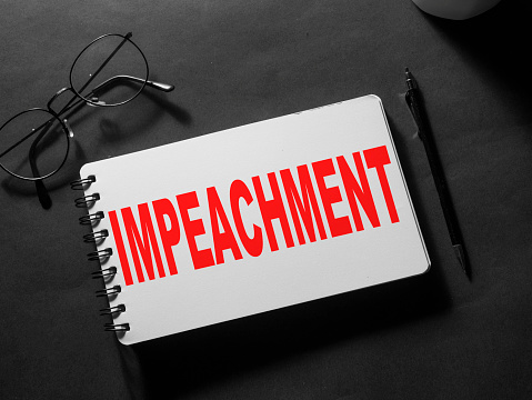 Impeachment, text words typography written on paper, politic and governance concept