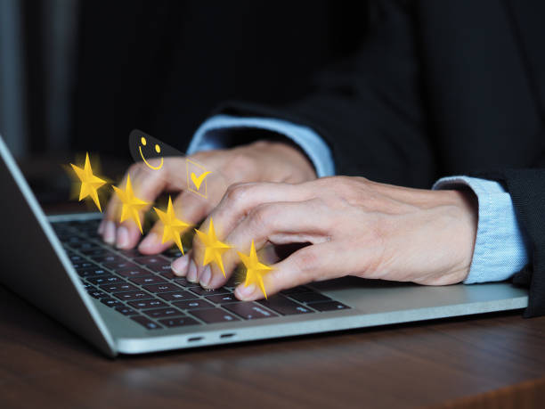 istock Customers rate products or services with 5 stars through online applications on the virtual screen above the computer keyboard. 1755334903
