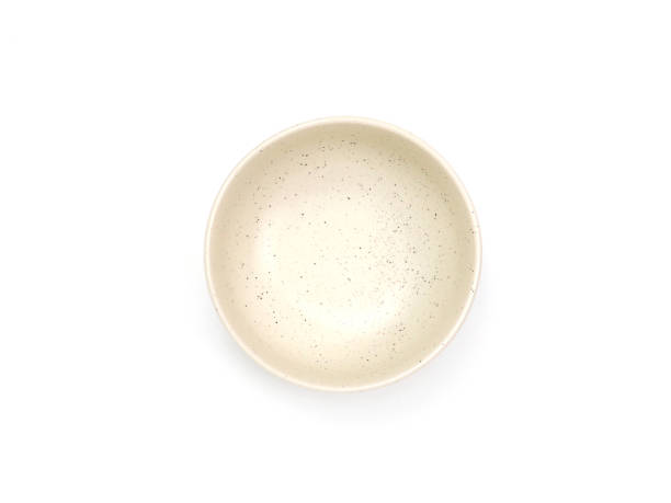 istock op view, empty beige round ceramic bowl with dotted isolated on a white background. 1755335942
