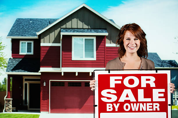 istock Woman with a For Sale signboard 175533603